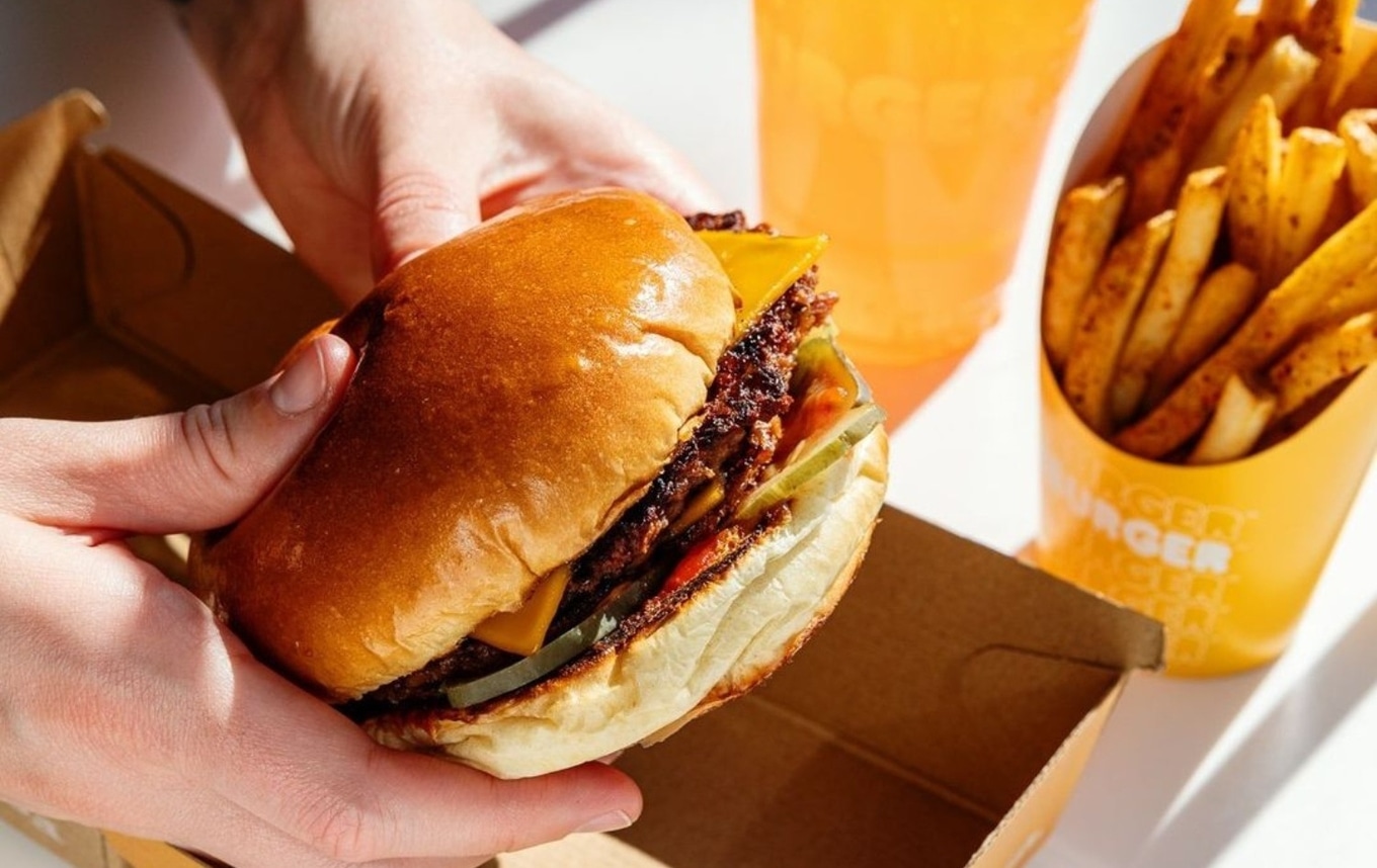 person holding burger